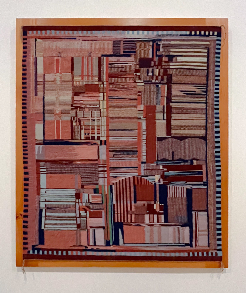 Colourful weaving pattern representing a computer chip. The pattern uses natiral coloured threads.